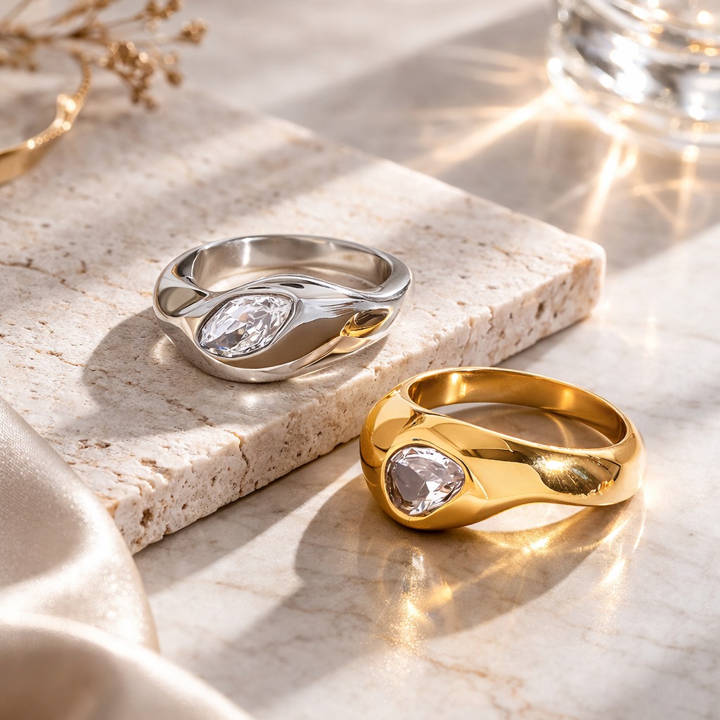 Gold and silver rings on a marble surface with a soft focus background