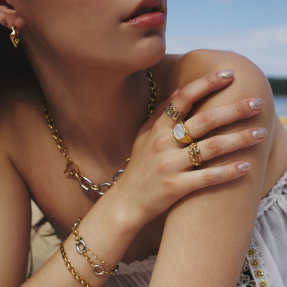 Close-up of a person wearing gold jewelry with a blurred background