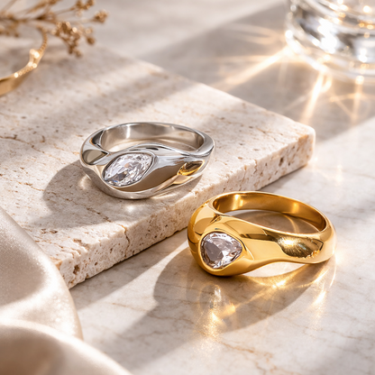 Gold and silver rings on a marble surface with a soft focus background